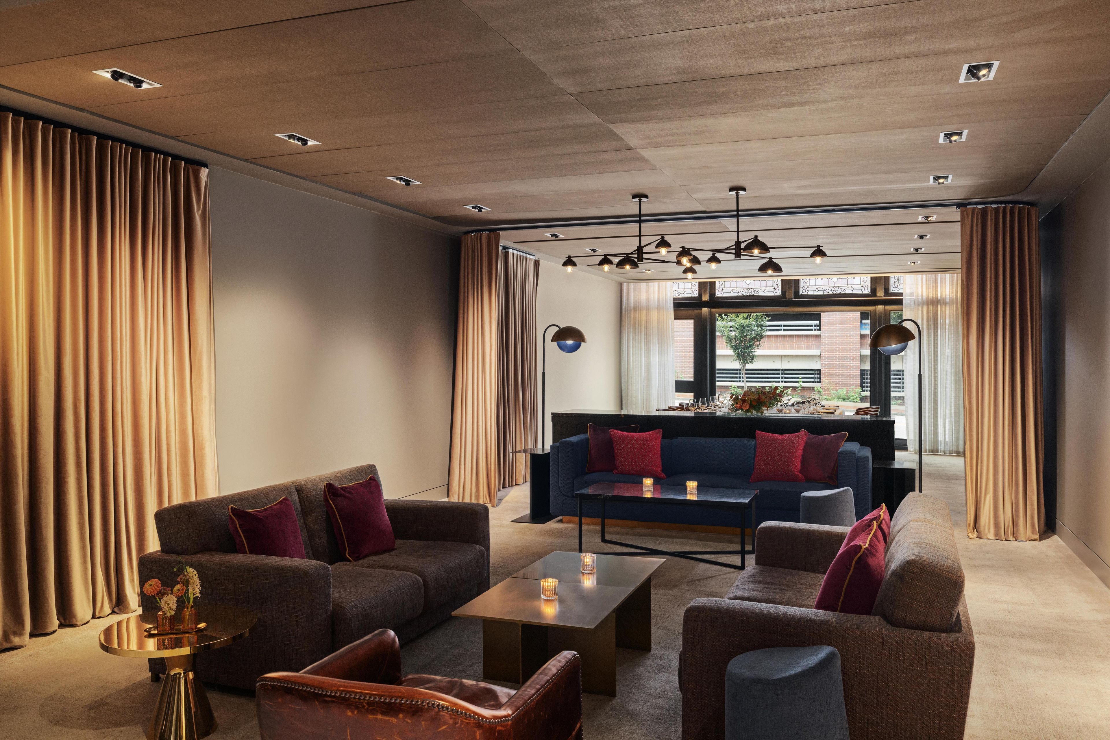 A modern living room with a sofa, armchairs, and a coffee table.