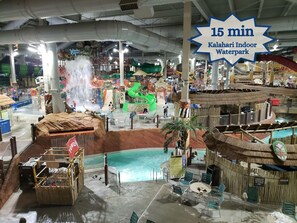 An indoor waterpark with various water features, slides, and a pool area. - Beautiful Lakefront House with Private Beach! BOOK NOW!  (Pocono Lake)