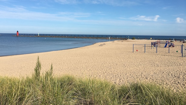 A beach with a lighthouse, a pier, and playground equipment. - Best Coast Cottage - Just a block and a half to the beach!!! (South Haven)