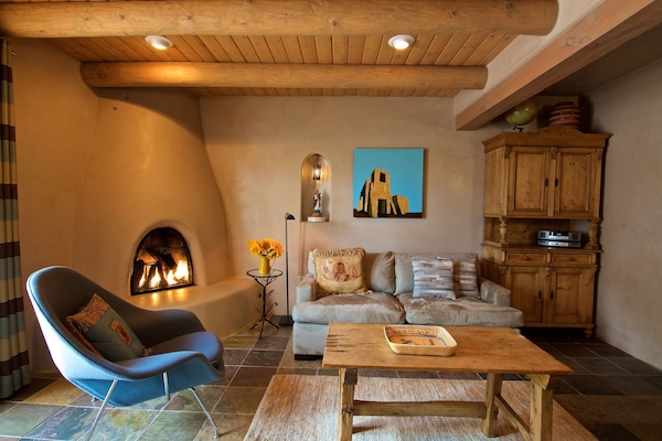 Living room, with gas-fired Kiva fireplace and down-filled soft.