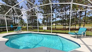 A swimming pool with a white deck, surrounded by a covered area with chairs. - 684od 5 Bedroom Home by RedAwning (Davenport)