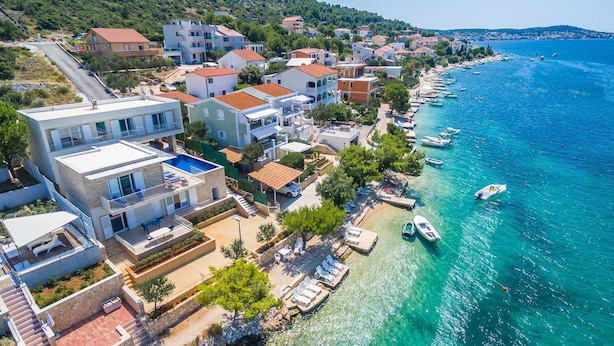 A coastal residential area with modern houses, a marina with boats, and a clear blue sea. - Villa La Perla - beachfront villa for ten, private pool and amazing views by MyWaycation (Rogoznica)