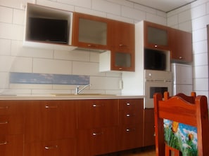 Enjoy cooking in this well-equipped kitchen with a microwave, stainless steel sink, and ample cabinetry.