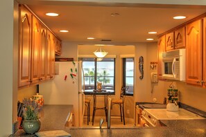 Enjoy meals in this kitchen with an oven, microwave, and stainless steel sink.
