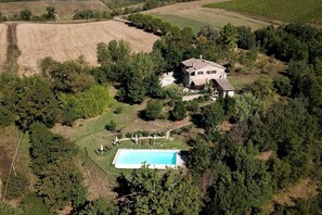 A large house surrounded by trees and fields, with a swimming pool in the front. - Authentic stone farmhouse, pool, view, bbq, wifi, bedrooms with bathroom and a/c (Resina I)