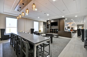 A modern conference room with a long table, chairs, and pendant lighting. - Home2 Suites Mt. Juliet, TN (Mount Juliet)