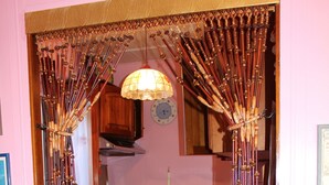 A kitchen with wooden cabinets, a stove, and a refrigerator. - Light vacation apartment in Forio (Isola d 'Ischia - NA) (Casamicciola Terme)
