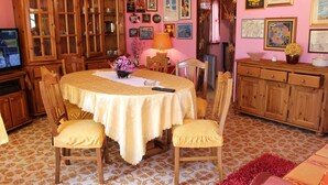 A dining area with a round table, chairs, and a cabinet. - Light vacation apartment in Forio (Isola d 'Ischia - NA) (Casamicciola Terme)