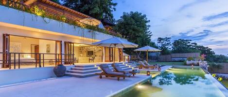 A lap pool, pool loungers