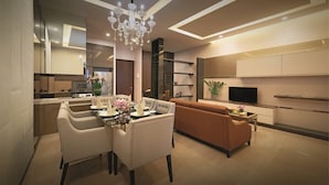 A modern living room with a dining area, a sofa, and a TV. - Dorsett Residences Bukit Bintang at Dorsett Kuala Lumpur (Kuala Lumpur)