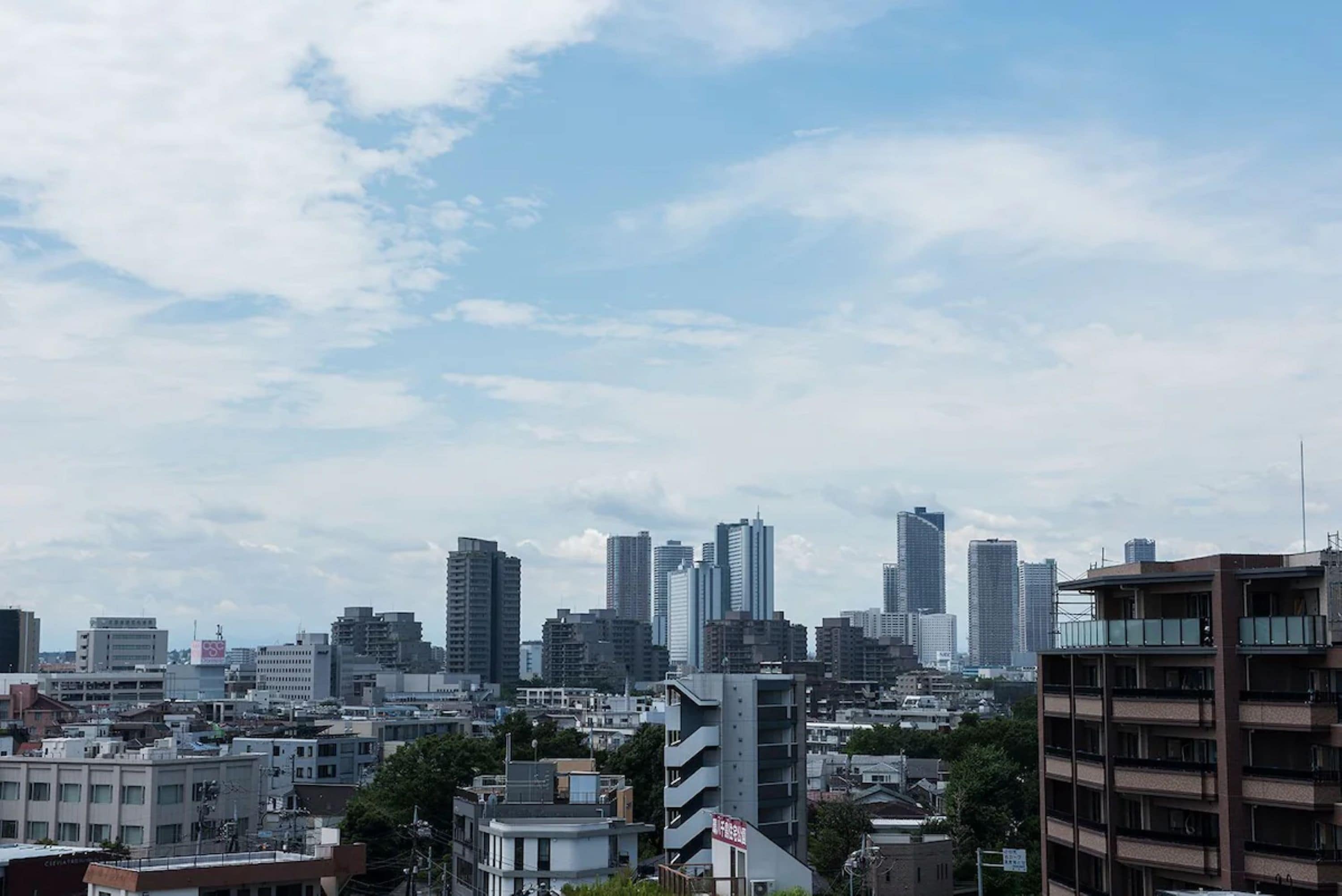 A cityscape with high-rise buildings and a mix of residential and commercial structures.