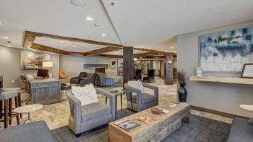A spacious lobby with a reception desk, seating area, and a fireplace.