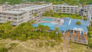 A hotel with multiple floors, a swimming pool, and a beach area. - Summer & July 4th Savings at Beachside Colony Tybee's ONLY Oceanfront Resort 2/2 (Tybee Island)