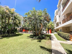 Relax in a serene outdoor space surrounded by palm trees and a beautifully manicured lawn.