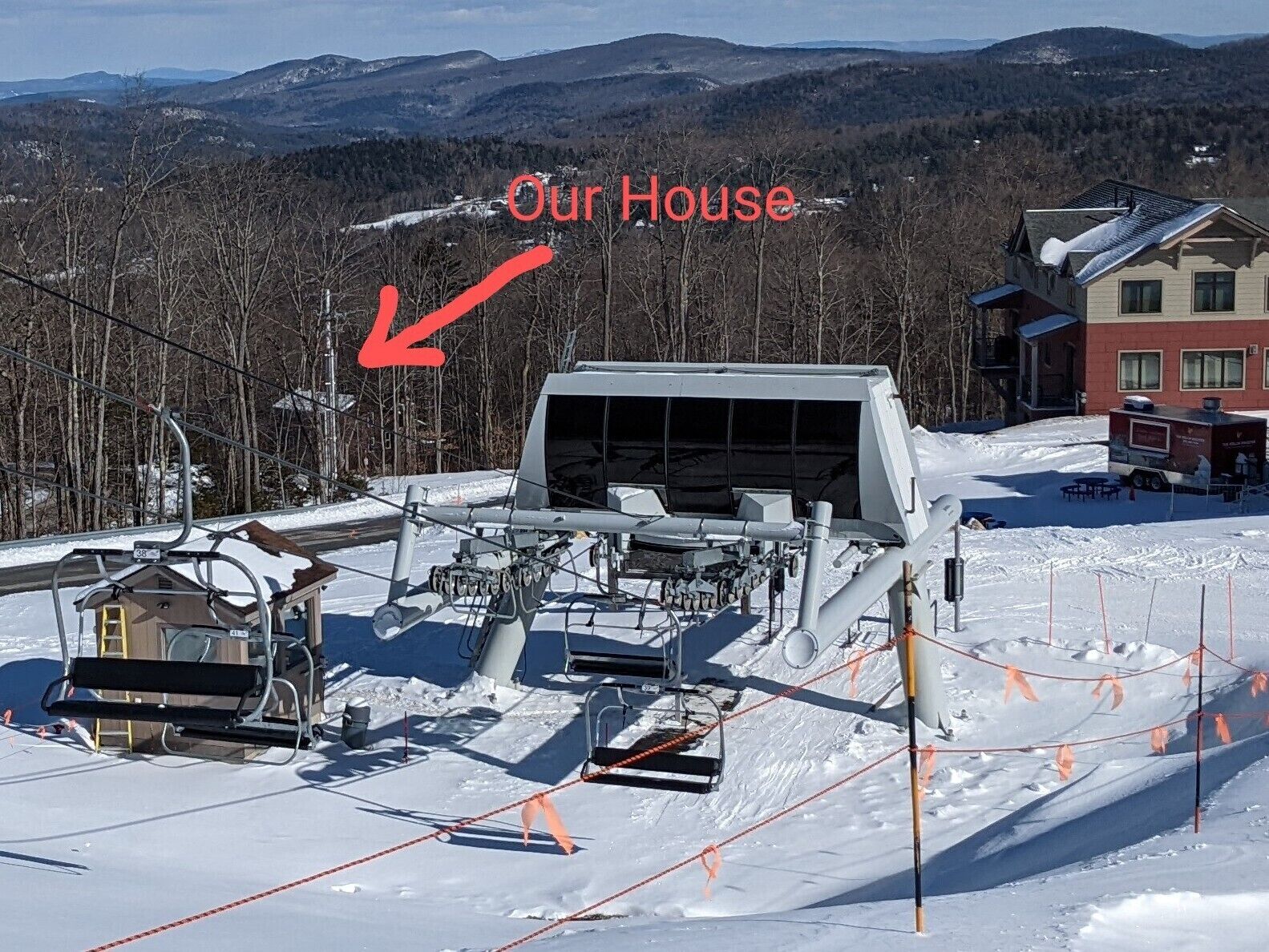 A ski lift area with a house labeled "Our House" in the background.