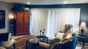 A living room with a sofa, armchair, coffee table, and a cabinet. - Yacht Club, Golf course, lake view, ground floor condo (Montgomery)