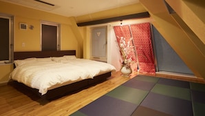 A bedroom with a bed, a window, a red curtain, and a wooden floor. - Bed & Breakfast RENGA – Hostel (Tokyo)