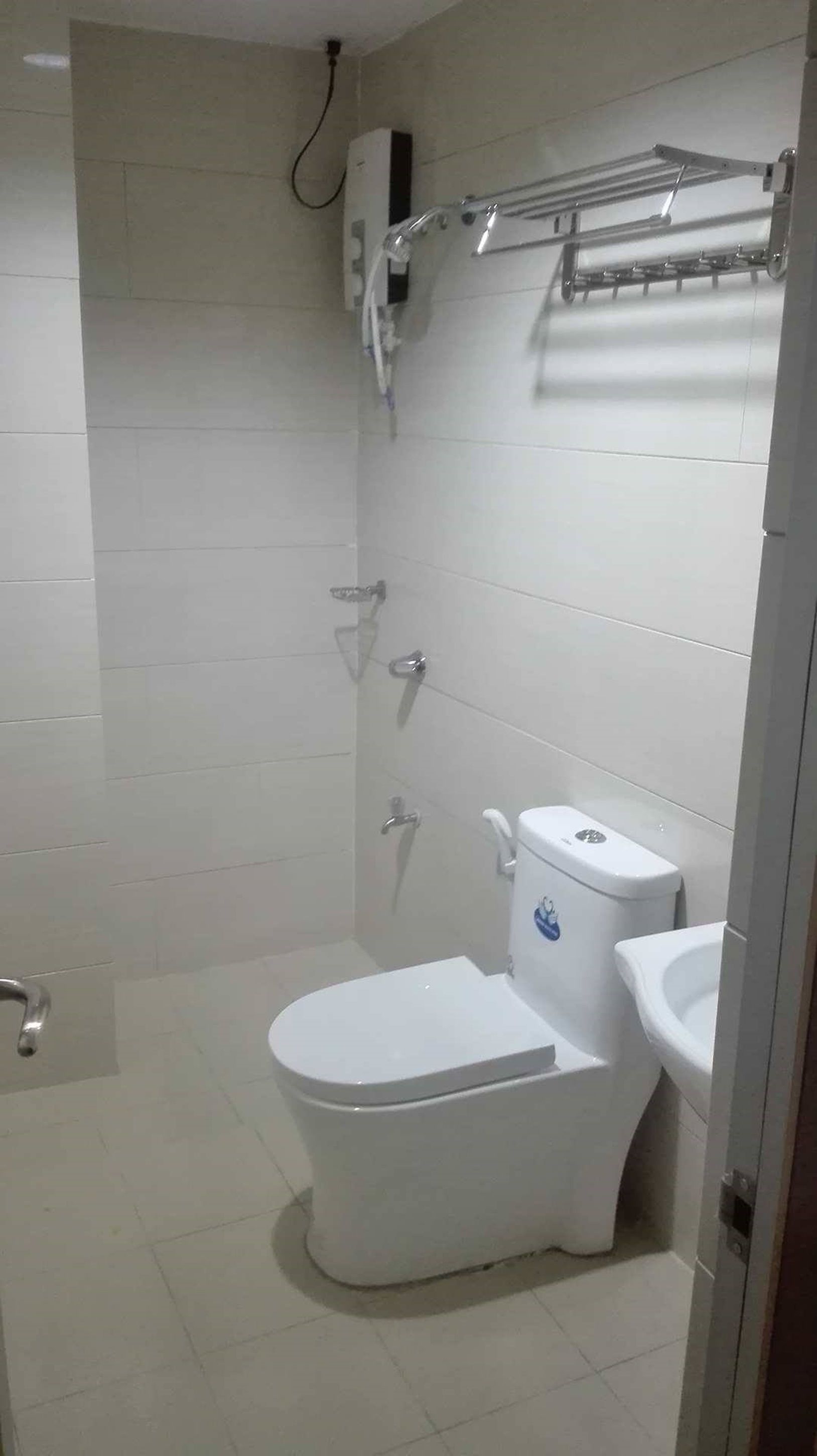 A modern bathroom with a toilet, bidet, and shower.