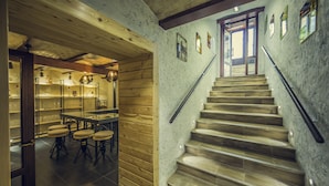 A wooden interior with a staircase leading to a second floor.
