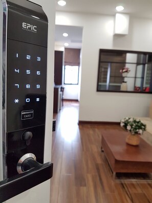 A modern, well-lit hallway with a digital keypad lock labeled "EPIC FUTUREPROOF" and a "CARD" button. - Tung Trang Hotel (Hanoi)