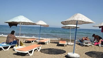 Plage, chaises longues, parasols