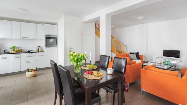 A modern apartment with a kitchen, dining area, and living room. - Swiss Star Oerlikon Lodge (Zürich)