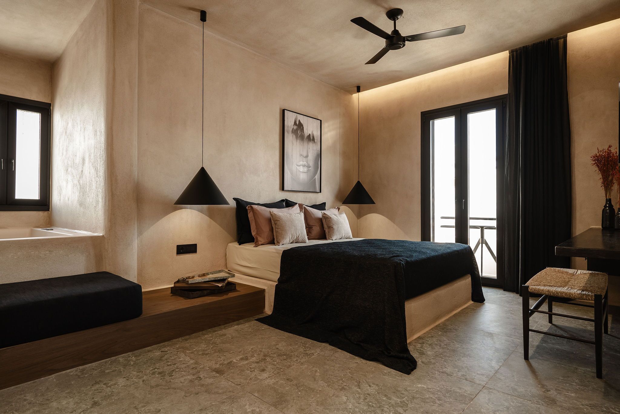 A modern bedroom with a bed, bedside tables, a desk, and a chair.