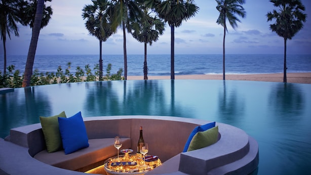 A poolside seating area with a view of the beach and ocean. - Jetwing Surf & Safari, A Luxury Reserve (Pottuvil)
