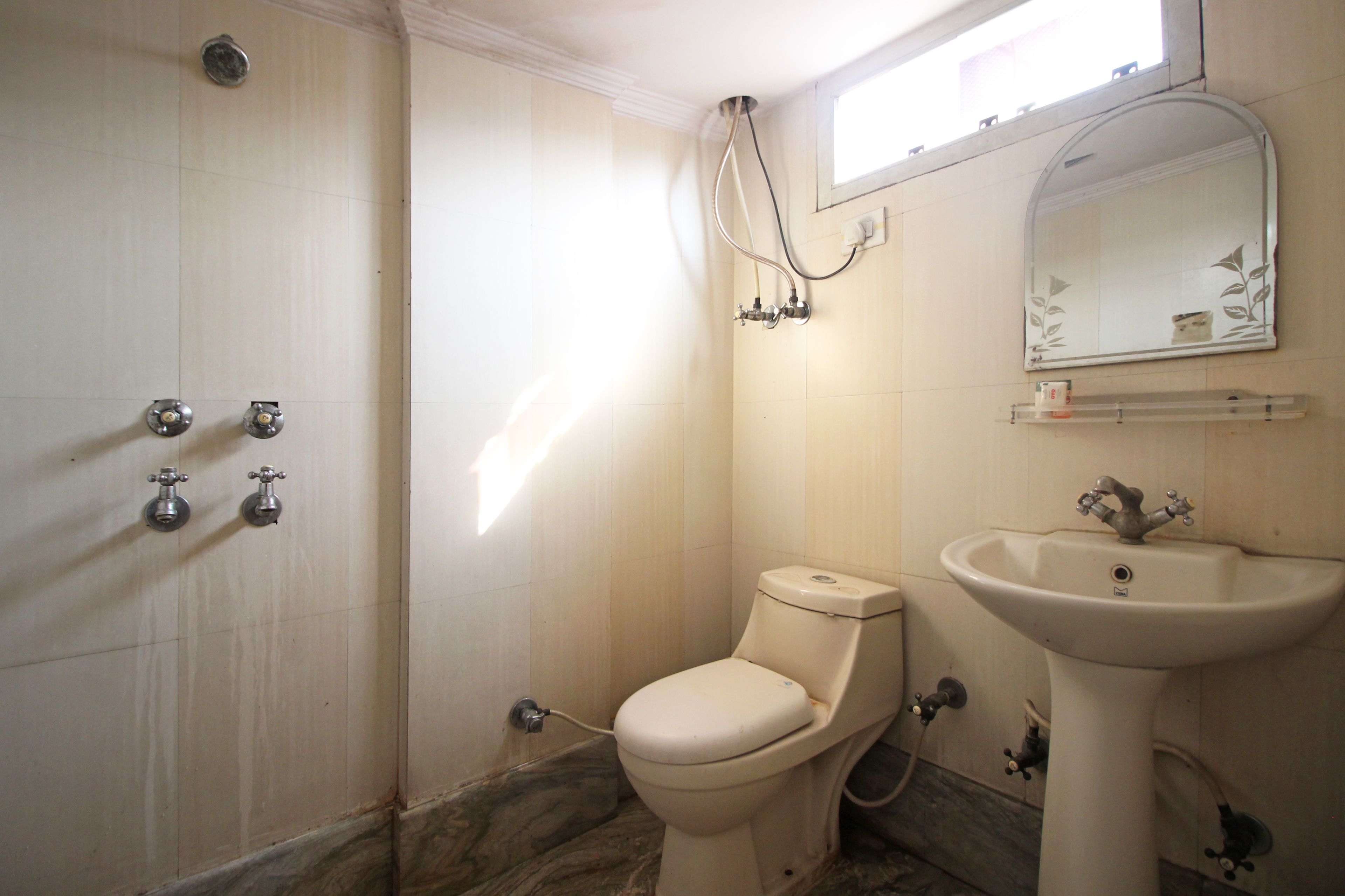 A bathroom with a toilet, sink, and shower.