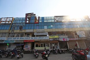 A building with multiple signs, including 'Hotel Madhur Regency' and 'MEDICA'.
