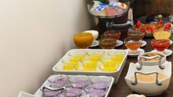 A breakfast buffet with various food items and beverages.