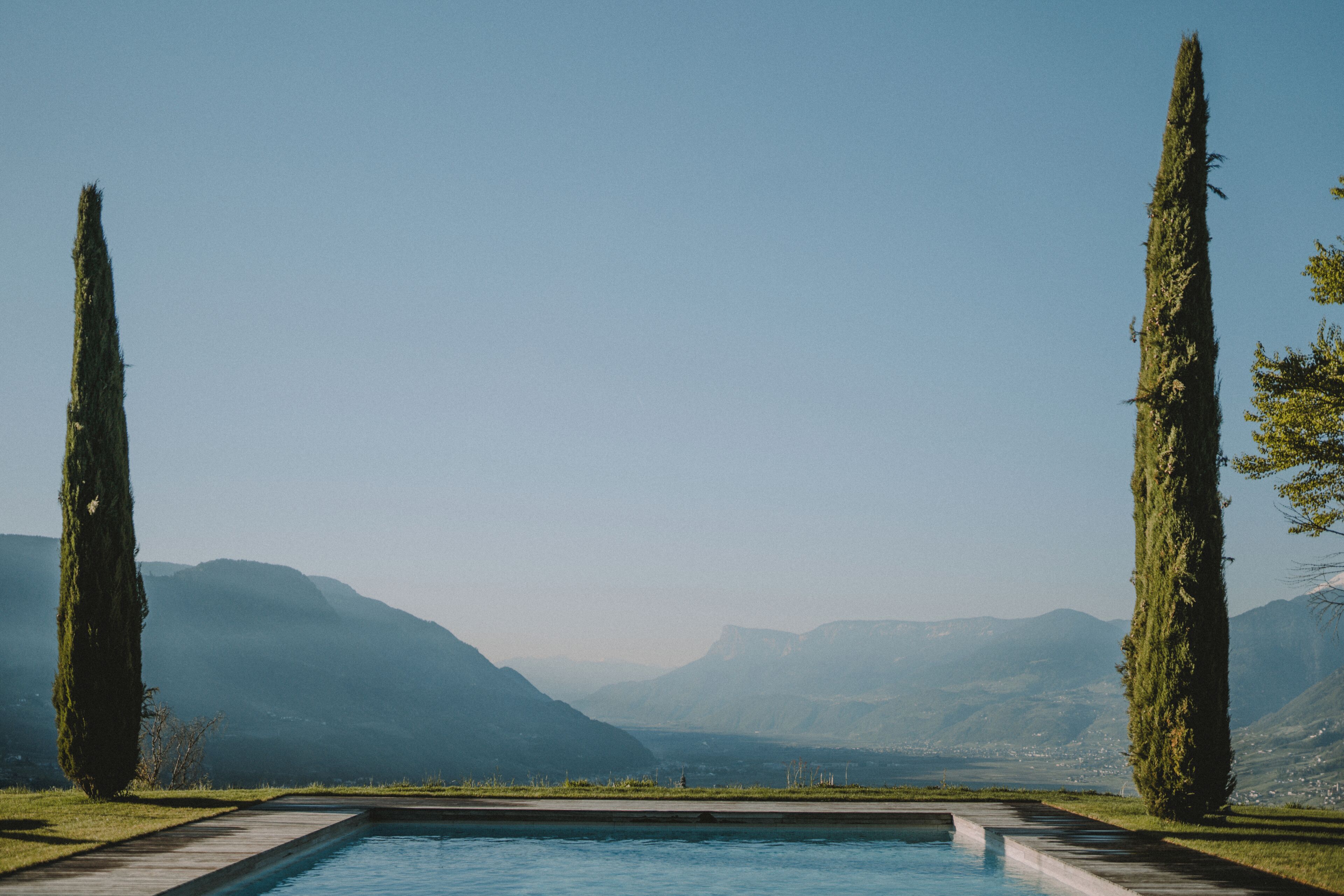 A rectangular pool with a clear view of distant mountains.