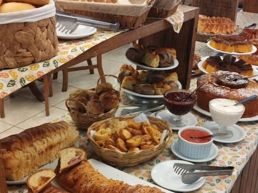 A buffet table with various breads and pastries.