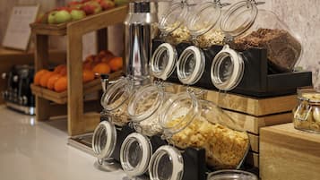 A breakfast buffet with various food items and containers.