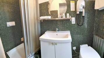 A bathroom with a white sink, a mirror, a towel rack, and a hairdryer.