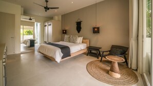 A spacious bedroom with a large bed, a ceiling fan, and a view of the outdoors through a sliding door. - Levi Villa (Seminyak)