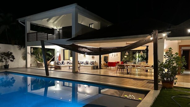 A modern two-story house with a swimming pool, outdoor seating area, and a covered patio. - Casa Panama Modern 5 bedroom villa 250m beach-  (Las Terrenas)