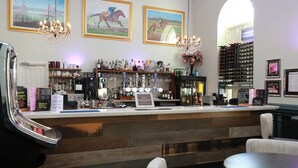 A bar area with a counter, bar stools, and a wine rack. - Kings Newmarket (Newmarket)