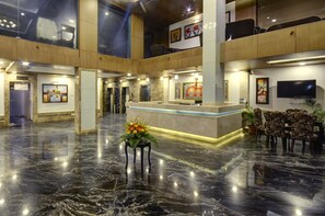 A spacious lobby with a marble floor, a reception desk, and seating area. - Pride Ananya Resort Puri (Puri)