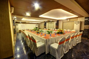 A conference room with a long table, chairs, and water bottles.