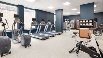 A gym with treadmills, stationary bikes, and exercise equipment.
