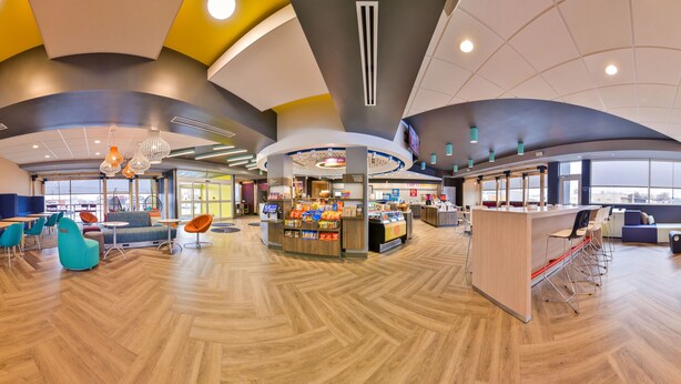 A spacious indoor area with a pool table, seating areas, and a food kiosk. - Tru by Hilton Stuttgart, AR (Stuttgart)