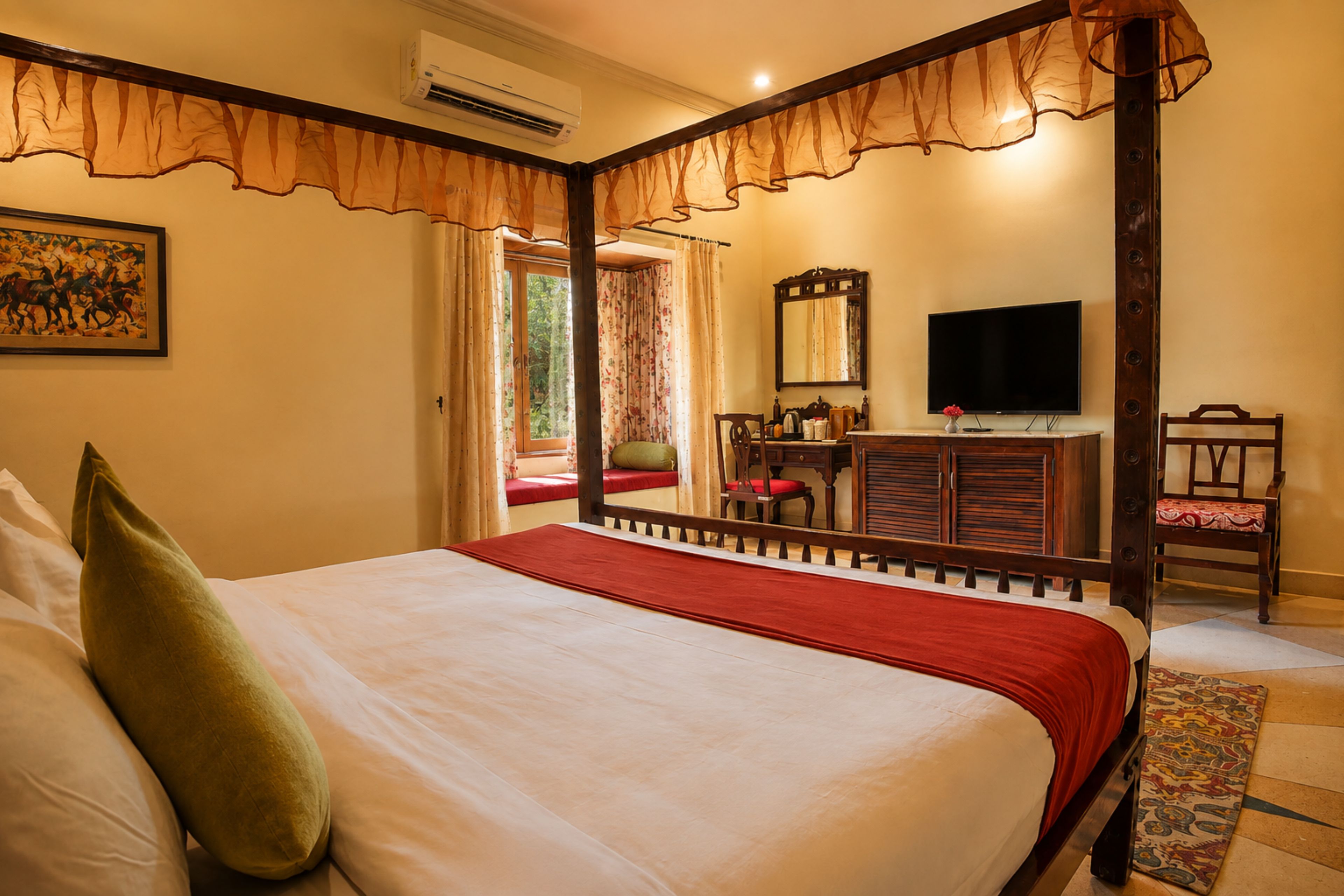 Habitación de hotel con una cama grande, televisión, escritorio con silla y ventana con cortinas.