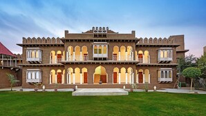A traditional building with multiple balconies and arched windows.