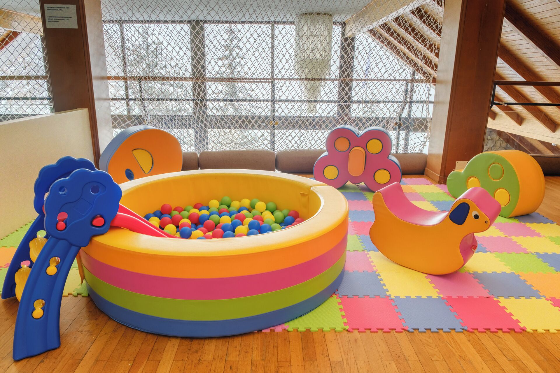 A play area with a ball pit, slides, and soft play furniture.