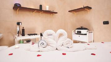 Relax in a stylish room with a large bed, bedside table, and candles.