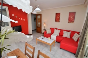 Relax in this stylish living room with a sofa, coffee table, and artwork.