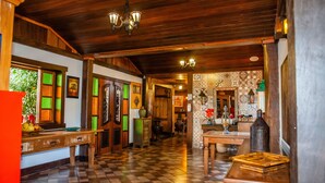 A traditional interior with wooden beams, checkered flooring, and vintage decor. - Pousada Tiradentes Village (Tiradentes)