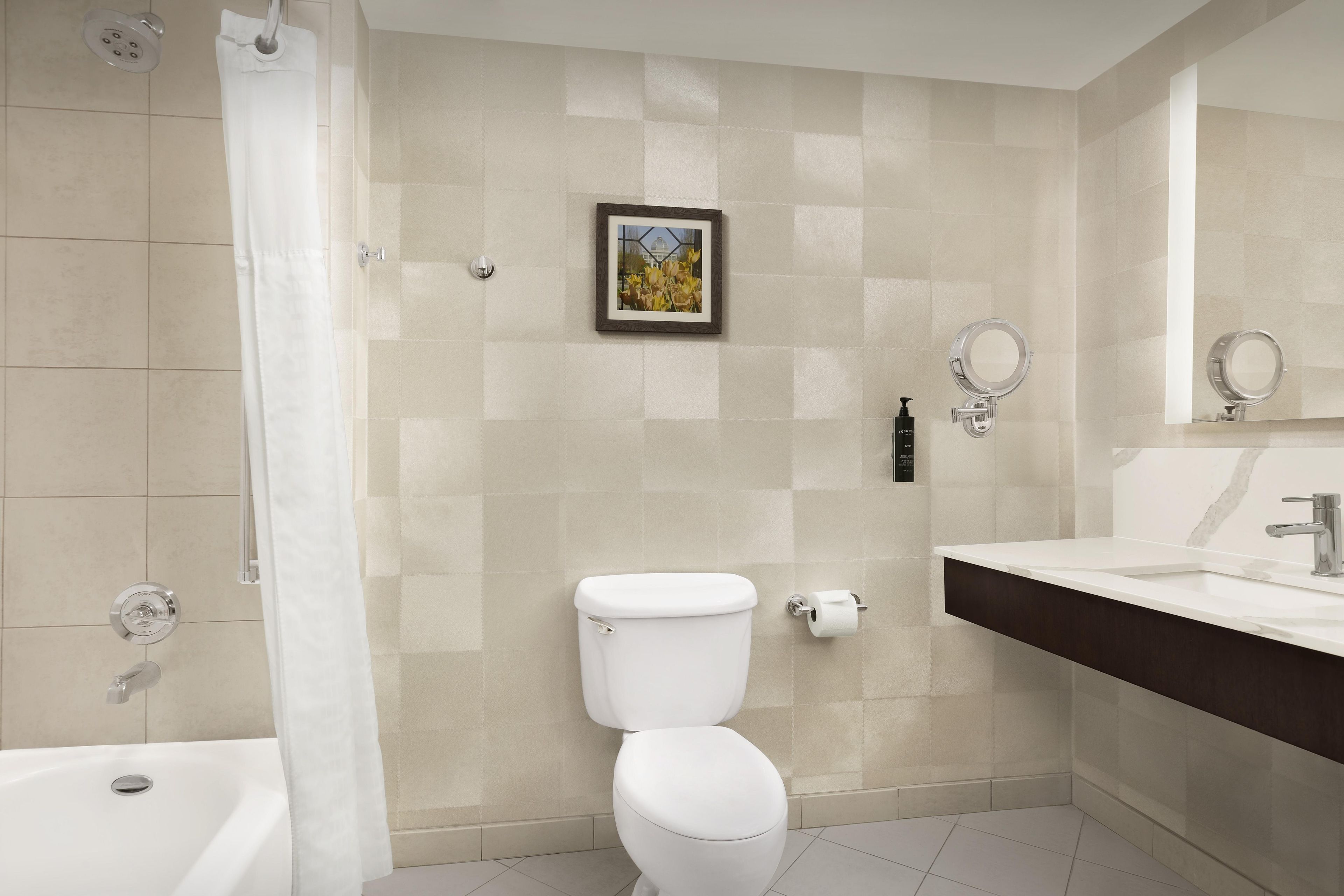 A modern bathroom with a toilet, bidet, and bathtub.