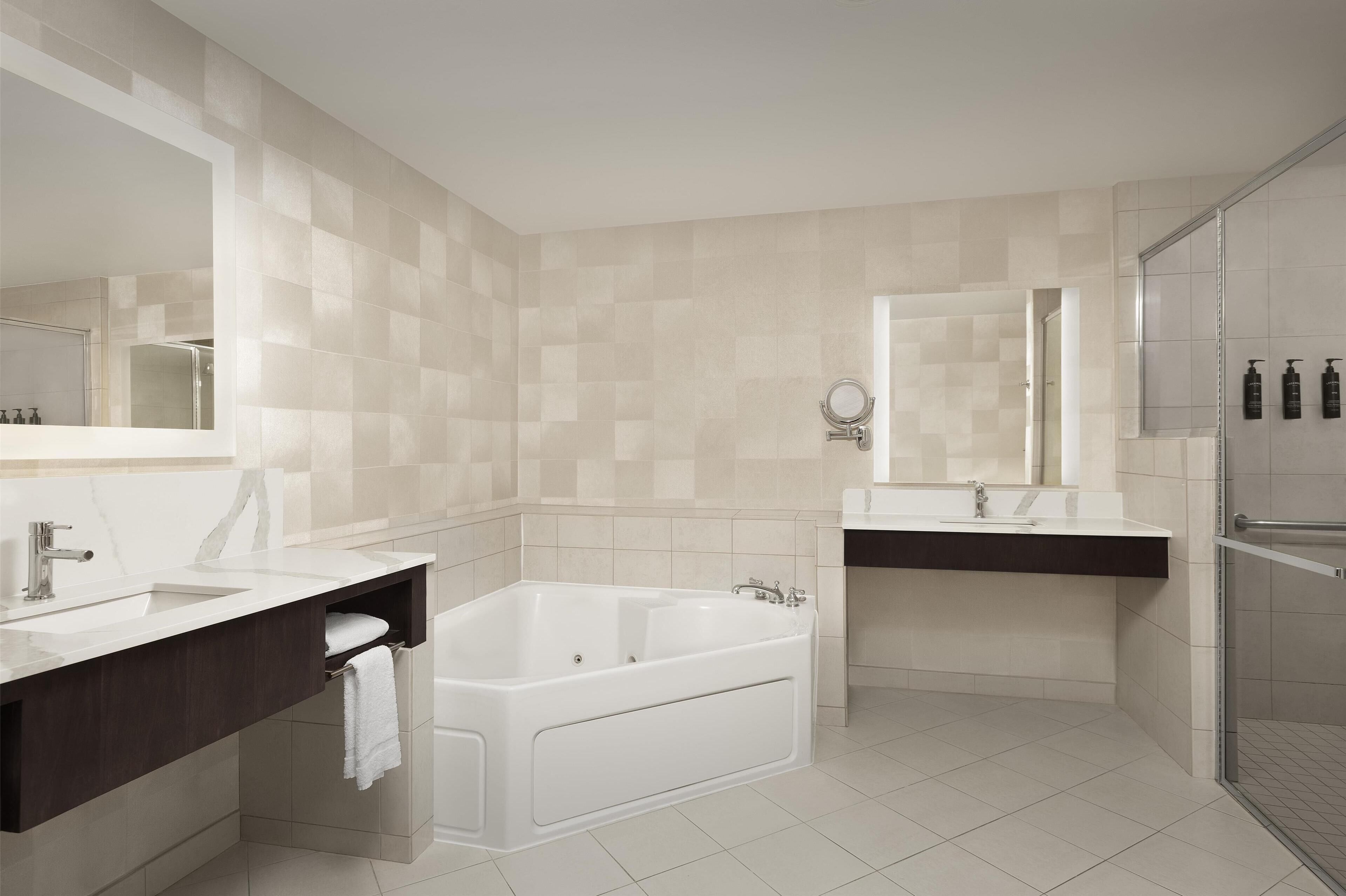 combined shower/bathtub, designer toiletries, hair dryer, towels